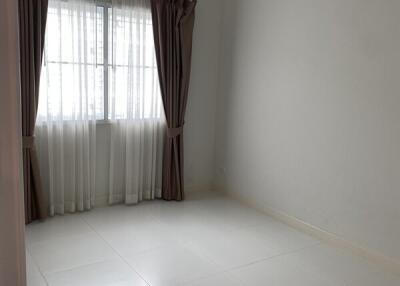 Empty bedroom with tiled floor and air conditioning