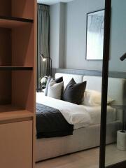 Modern bedroom with cozy bed, pillows, and a nightstand