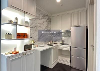 Modern white kitchen with marble backsplash and stainless steel appliances