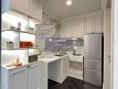 Modern white kitchen with marble backsplash and stainless steel appliances