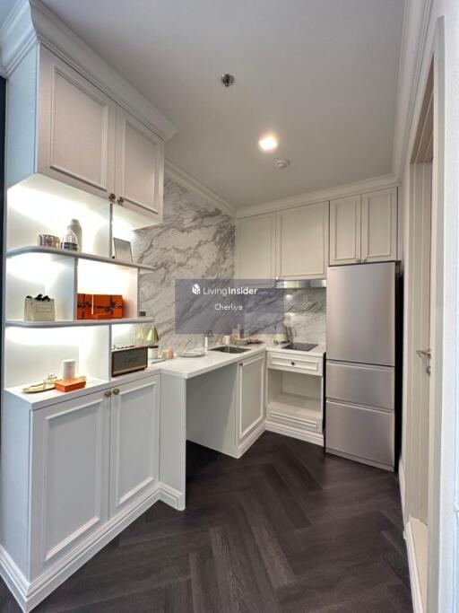 Modern white kitchen with marble backsplash and stainless steel appliances