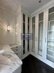 Luxurious walk-in closet with marble countertop and built-in wardrobes