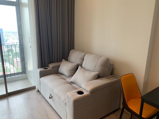 Small living room with grey sofa and yellow chair