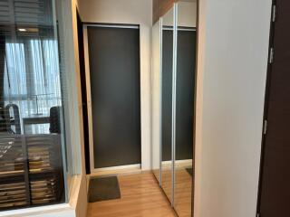 Modern hallway with sliding doors and mirrored closet