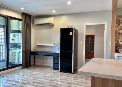 Modern kitchen with appliances and tile flooring