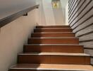 Outdoor staircase with brown steps leading to a door