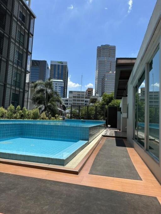 A rooftop pool with a view of skyscrapers