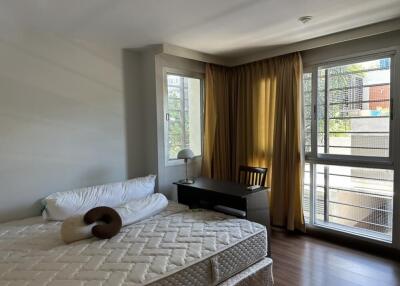 Modern bedroom with large windows and natural light