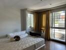 Modern bedroom with large windows and natural light