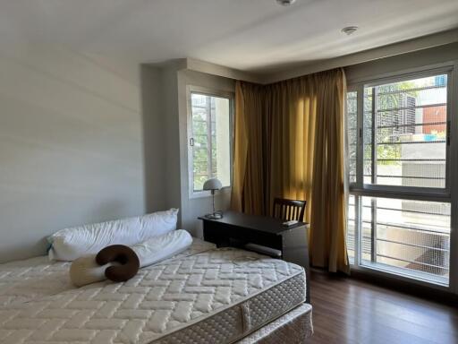 Modern bedroom with large windows and natural light