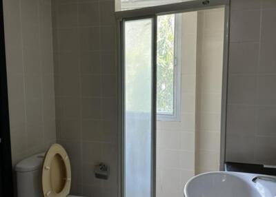 Bathroom with toilet, sink, and large window