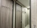 Modern bathroom with shower area and hooks on the door