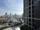 View of cityscape and neighboring building from a high-rise apartment