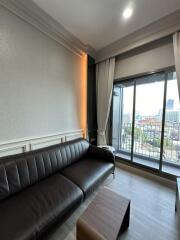 Modern living room with a sofa and balcony view