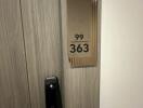 Door with electronic lock and room number 363