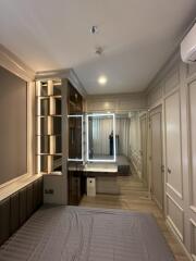 Modern bedroom with built-in lighting and dressing area