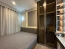 Modern bedroom with grey tones and built-in storage