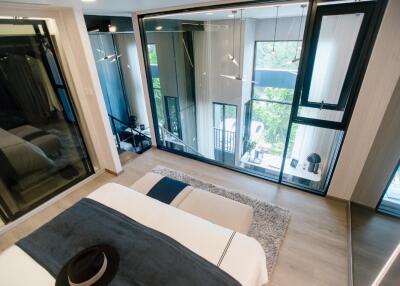 Modern bedroom with large windows and balcony view