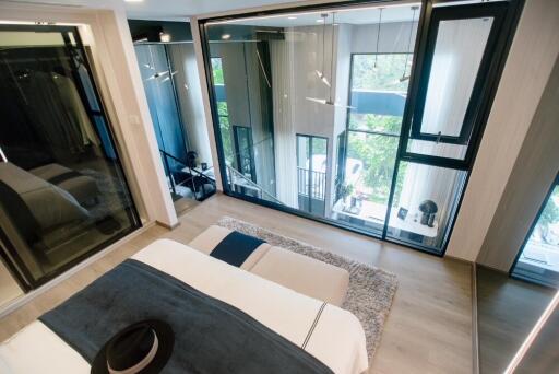 Modern bedroom with large windows and balcony view