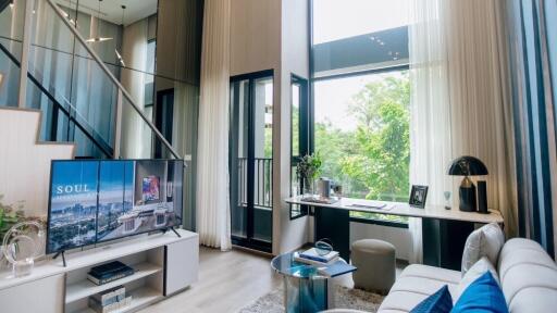 Modern living room with large windows and high ceilings