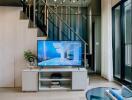 Modern living room with a staircase and television