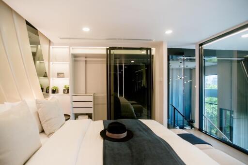 Modern bedroom with large windows and contemporary furnishings