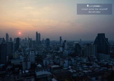 City skyline at sunset from a high-rise balcony