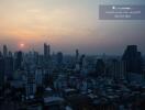 City skyline at sunset from a high-rise balcony