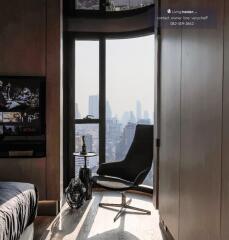 Modern living room with city view, chair, and TV