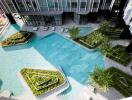 Aerial view of a modern residential building with a unique pool area