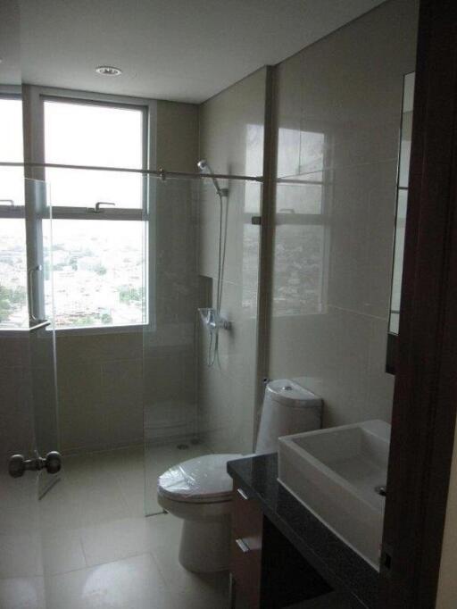 Modern bathroom with glass partition and large windows