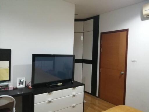 Cozy bedroom with modern furniture and a television