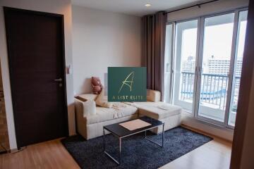 Cozy living room with a balcony and modern furnishings