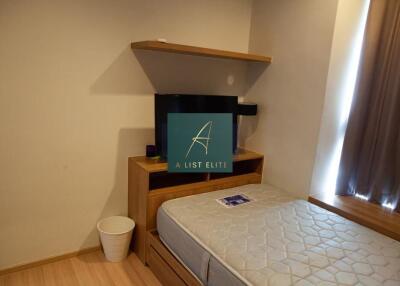 Small bedroom with a bed, TV, and a shelf