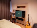 Bedroom with TV and guitar