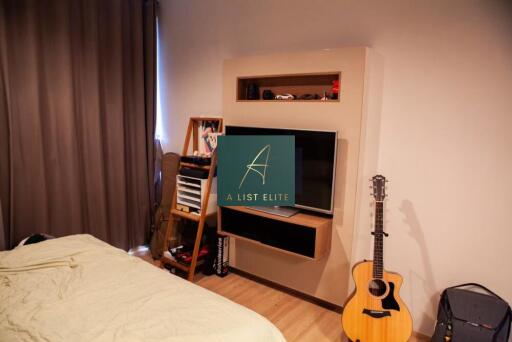 Bedroom with TV and guitar