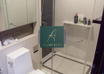 Modern bathroom with a glass-enclosed shower and white toilet