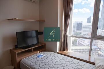 Bedroom with large window and city view