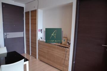 Condo entryway with wooden cabinets