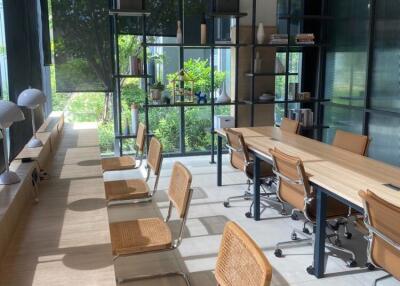 Modern coworking space with large windows and natural light