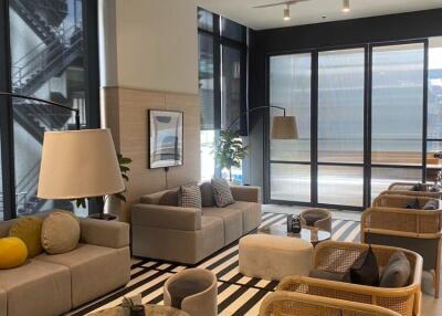 Modern living room with sofas, coffee table, and large windows