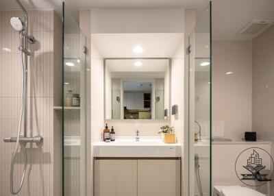 Modern bathroom with shower, sink, and mirror