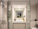 Modern bathroom with shower, sink, and mirror