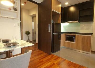 Modern kitchen and dining area with wooden floors and contemporary design