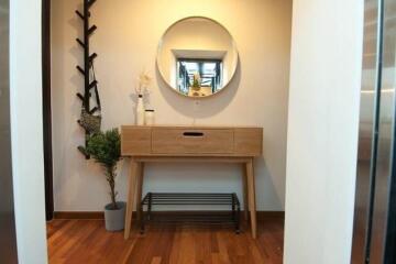 Hallway with wooden console table and round mirror