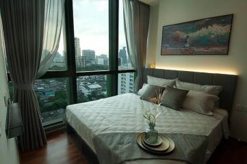 Modern bedroom with large windows and city view