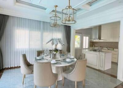 Bright dining area with elegant table and chairs, adjacent to modern kitchen