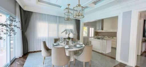 Bright dining area with elegant table and chairs, adjacent to modern kitchen