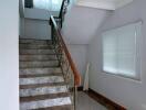 Elegant marble staircase in a bright hallway