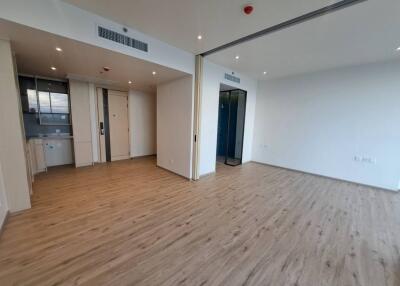 Spacious living room with wooden flooring and natural light